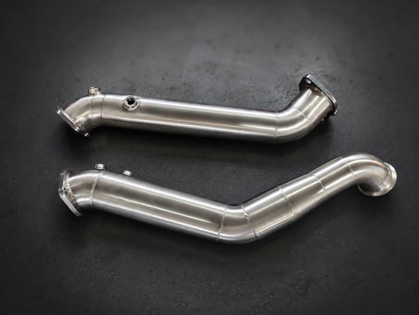 Two finished stainless steel downpipes