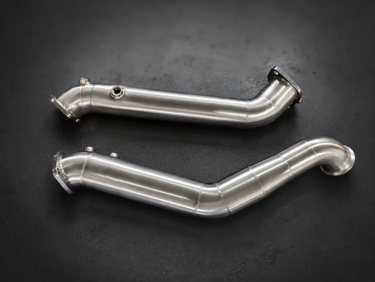 Two finished stainless steel downpipes
