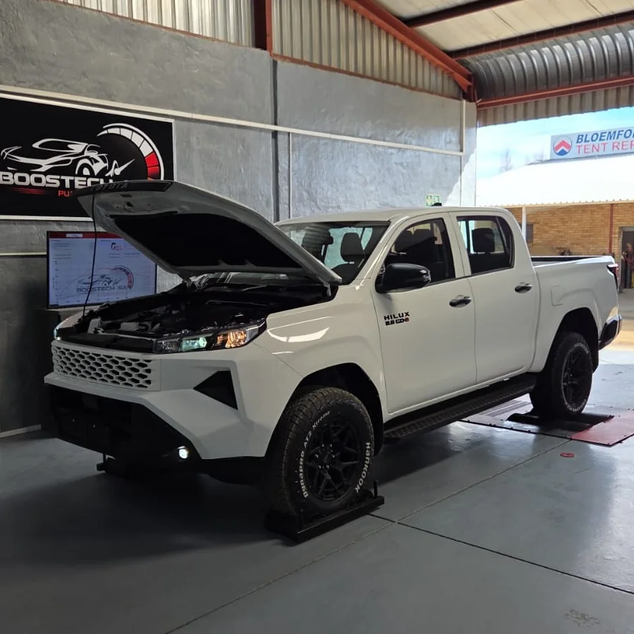 White Toyota Hilux with its bonnet open in the Boostech Bloemfontein workshop